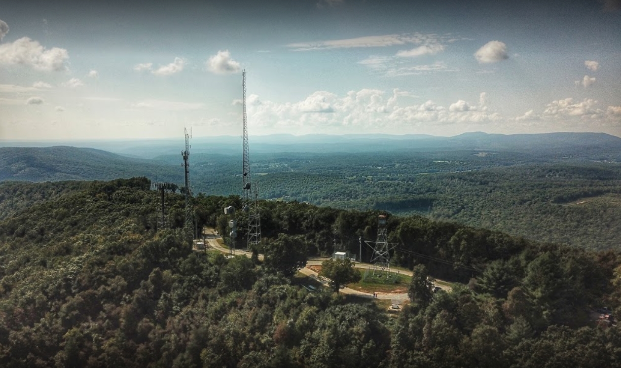 Mt. Roosevelt summit with fire tower and communications towers overlooking the forest